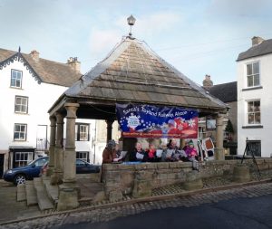 Christmas Carols being sung at the Market Cross